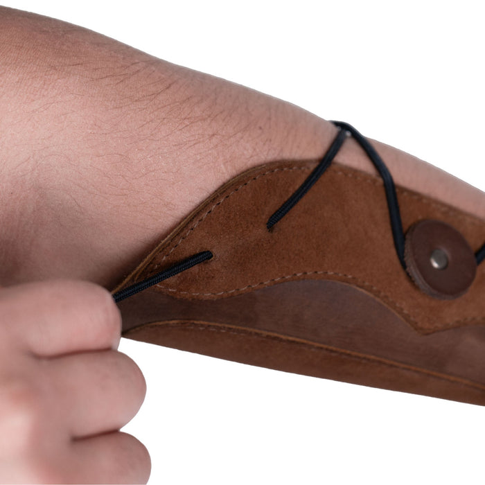 Detail image focusing on the adjustable strap and unique design of the Elastic Archery Bracer by Valhalla Gear, made for comfort and protection while practicing archery. This wrist guard is handcrafted from full grain leather, showcasing a perfect fit for both casual users and cosplay enthusiasts.