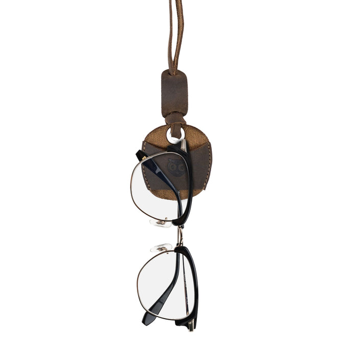 Hide & Drink Eyeglasses Holder showcasing eyeglasses held on a neck strap, made of durable full grain leather. Perfect Eyeglasses Holder for Men and Women, featuring a stylish design ideal for both sunglasses and reading glasses. Artisan, handmade in La Antigua Guatemala & Oaxaca Mexico.
