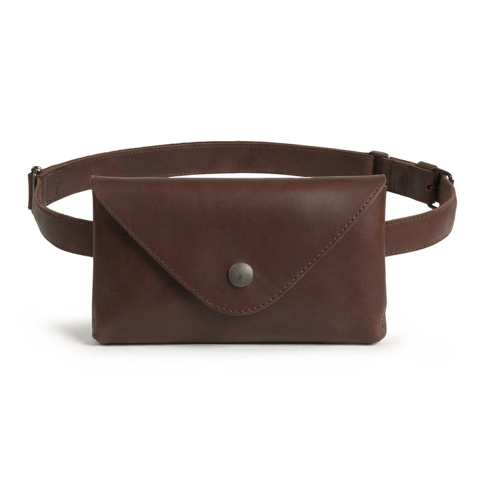 Hide & Drink's Fancy Fanny Pack in rustic full grain leather. This artisan-made waist pouch combines style and functionality, perfect as a vintage purse or phone holder. Ideal for easy travel for digital nomads, featuring small batch production, hand cut, and hand sewn craftsmanship, handmade in La Antigua Guatemala.