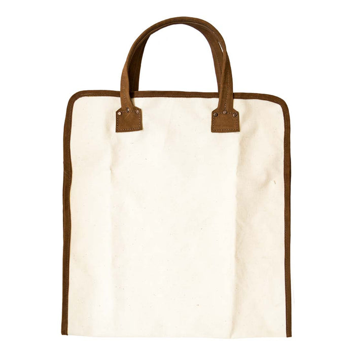 Hide & Drink Firewood Bag in an upright position, designed with strong handles and crafted from long-lasting materials, ideal for heavy loads. Firewood Bag With Leather Liner, Full Grain Leather, StockyardX, Small Batch Production, Hand Cut, Hand Sewn, Fire Branded, Artisan, Handmade in La Antigua Guatemala & Oaxaca Mexico.