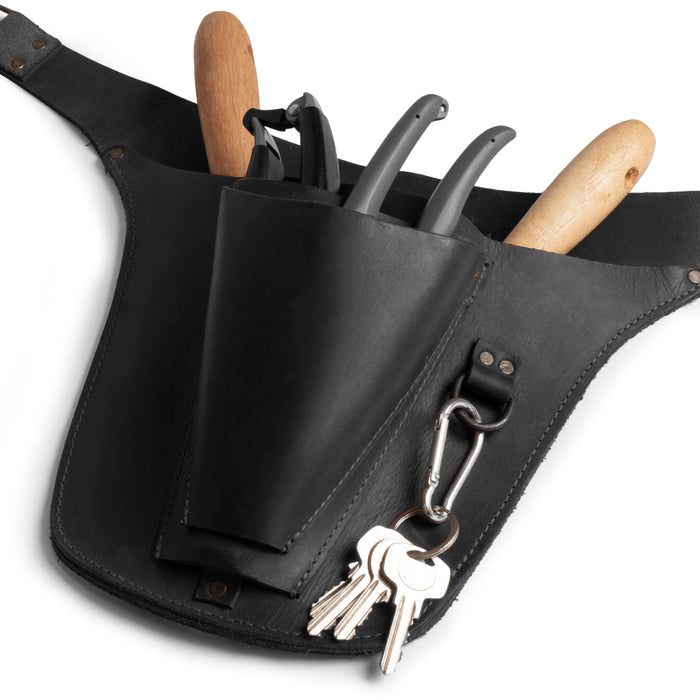Close-up view of Hide & Drink's black Florist Tool Belt featuring robust storage options in Full Grain Leather. This Florist Tool Belt for Men & Women combines practicality and style, ideal for electricians and crafters. Handcrafted with care in La Antigua Guatemala & Oaxaca Mexico, highlighting small batch production.