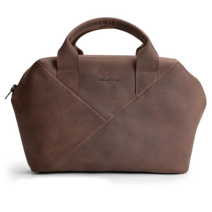 Heather's Fluffy Purse made of Full Grain Leather, showcasing its stylish design. This Leather Fluffy Purse serves as a Handbag for Women perfect for a night out, a Rectangular Purse with Zipper for essentials, and a Travel Make Up Bag. Artisan-made through Small Batch Production, this bag features Hand Cut and Hand Sewn elements, Fire Branded for authenticity, and is Handmade in La Antigua Guatemala & Oaxaca Mexico.