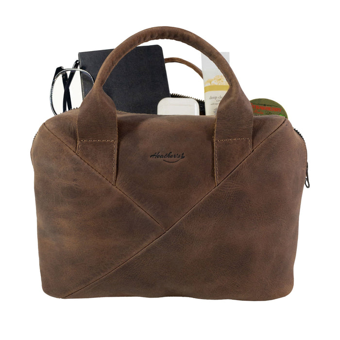 Heather's Fluffy Purse open to display its spacious interior, crafted from Full Grain Leather. This Leather Fluffy Purse makes an excellent Handbag for Women or a stylish Night Bag, along with its usefulness as a Rectangular Purse with Zipper or Travel Make Up Bag. Celebrated for its quality, this bag reflects Small Batch Production, Hand Cut, Hand Sewn details, Fire Branded, and is Handmade in La Antigua Guatemala & Oaxaca Mexico.