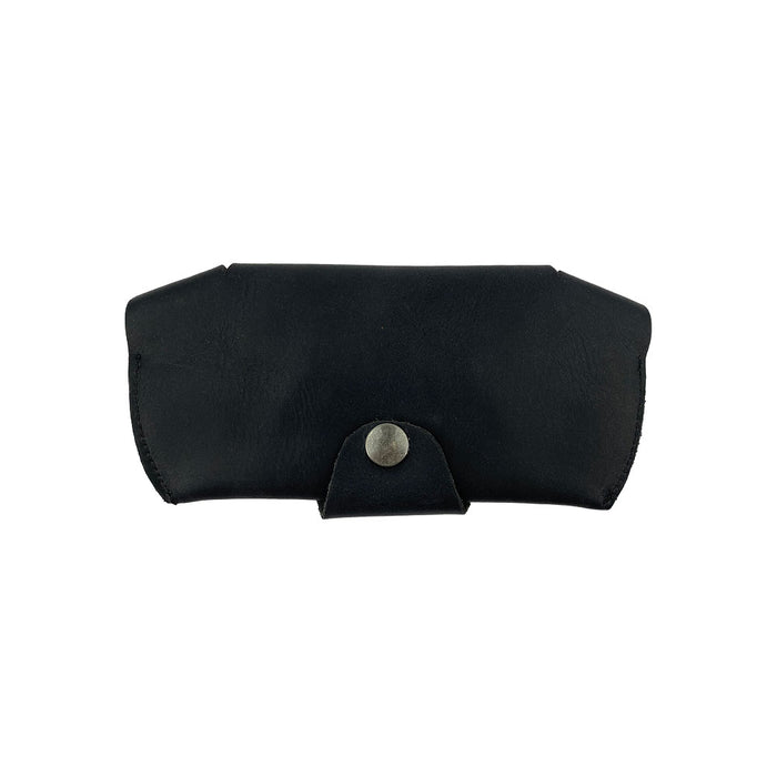 Back view of the black Foldable Sunglass Case by Hide & Drink with a secure closure. Famed for its artisan craftsmanship, this Full Grain Leather case highlights small batch production and fire branding for authenticity.