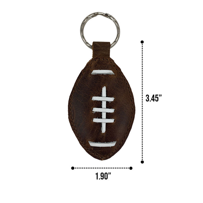 Dimensions of the Football Key Chain by Hide & Drink displayed for reference, emphasizing its compact and functional design. Made from Full Grain Leather, a perfect gift for sports lovers with tags Football Keychain, Small Batch Production, Hand Cut, Hand Sewn, Fire Branded, Artisan, Handmade in La Antigua Guatemala & Oaxaca Mexico.