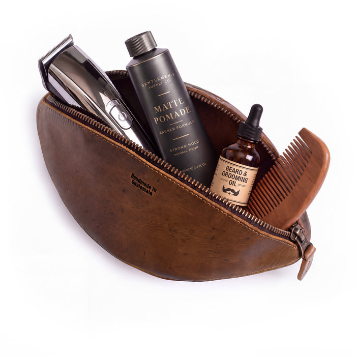 Interior of the Football Toiletry Bag by Hide & Drink, revealing its spacious design and durable full grain leather. This Gameday Football Dopp Toiletry Bag is perfect for travel organization, serving as a reliable bag for grooming essentials and shaving kit storage. Handmade in small batches, it highlights exceptional artisan work from La Antigua Guatemala.