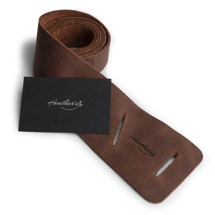 Heather's Formal Belt for Women, featuring a stylish presentation with tags highlighting its unique characteristics. This Full Grain Leather Waist Strap is a perfect example of Small Batch Production with hand cut, hand sewn, and fire branded attributes, artisan made in La Antigua Guatemala & Oaxaca Mexico.