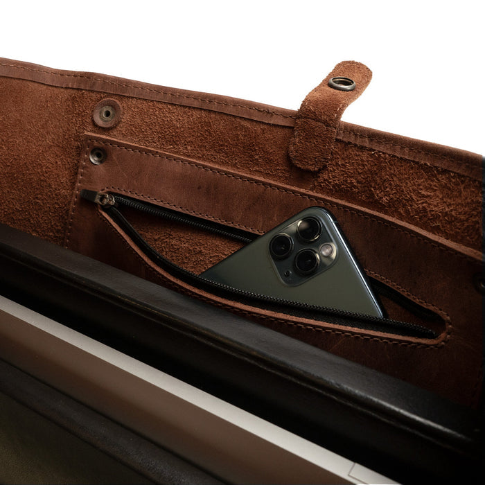 Close-up of the interior of a Formal Tote Bag by Hide & Drink, featuring a convenient pocket pouch with zipper for added security. This classy handbag is designed for women on the go, combining functionality with style for both business and casual settings. The soft leather design makes it an essential accessory for any outfit.