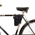 Bicycle outfitted with Hide & Drink‚Äôs Triangular Frame Bag in black. This Full Grain Leather bag is ideal for storing bike repair tools and is a stylish accessory for all bikers, handcrafted in La Antigua Guatemala & Oaxaca Mexico.
