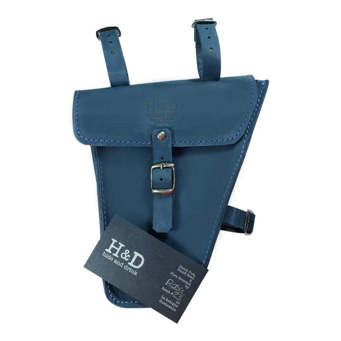 Showcasing Hide & Drink's blue Frame Bag For Bicycle with a tag, emphasizing its artisan heritage. This Full Grain Leather bike tool pouch is an essential storage solution for bikers, reflecting small batch production and handmade quality in La Antigua Guatemala & Oaxaca Mexico.