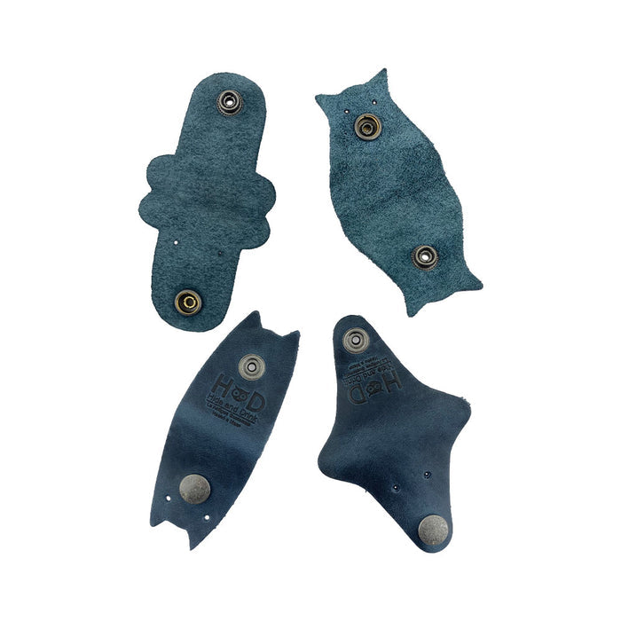 Furry Friends Cord Keeper (4-Pack) with delightful animal shapes, made from premium full grain leather by Hide & Drink, ideal for keeping cords organized. Furry Friends 4-Pack Cord Keeper (Cord Clam), Full Grain Leather, StockyardX, Small Batch Production, Hand Cut, Hand Sewn, Fire Branded, Artisan, Handmade in La Antigua Guatemala & Oaxaca Mexico.