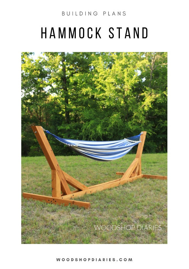 Wooden hammock stand with a blue and white striped hammock in a grassy area with trees.