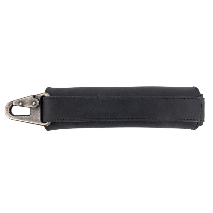 Side view of a black Harmonica Case by Hide & Drink, featuring a sturdy clasp for secure carrying. This full grain leather protector is an essential musician accessory, showcasing artisan quality and small batch production from La Antigua Guatemala.