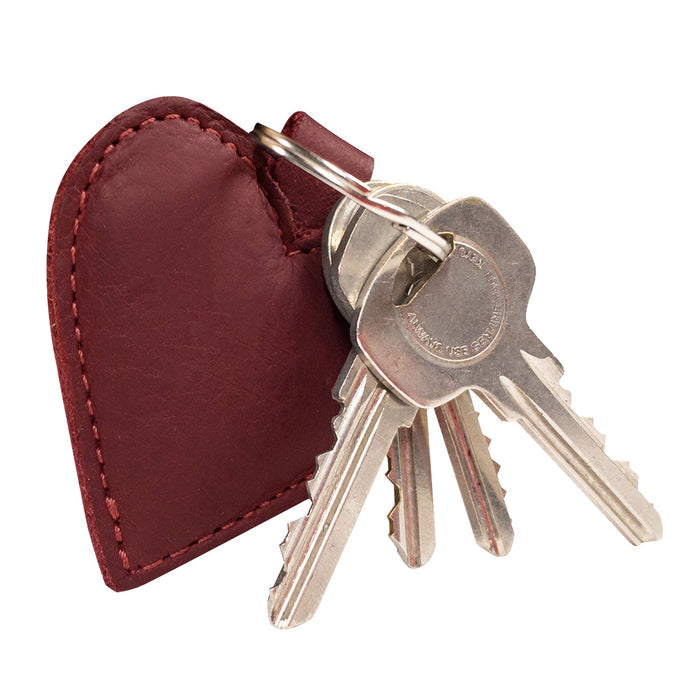 Close-up view of the Heart Keychain by Hide & Drink, showcasing its heart shape and rich leather texture. This heart-shape keychain doubles as a key organizer and is crafted with fire branded detailing. A testament to artisan handmade craftsmanship in La Antigua Guatemala & Oaxaca Mexico, it’s a must-have for anyone seeking cute accessories.