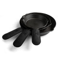 A striking black version of Cast Leather Co.'s Hot Handle Covers (Set of 3), designed for cast iron skillets with heat-resistant properties. These artisan skillet handle covers are handmade in La Antigua Guatemala and Oaxaca Mexico, showcasing superb craftsmanship.