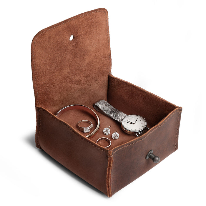 Interior shot of a Hide & Drink Jewelry Pouch filled with rings, emphasizing its functionality and style as a precious articles storage organizer. This artisan gift is made from full grain leather and shines as an ideal wedding keepsake for groomsmen.