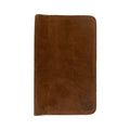 View of a closed brown Journal Cover for Moleskine Cahier L (5 x 8.25 in.) by Hide & Drink. This rustic protector is handcrafted from full grain leather, making it ideal for large size (5 x 8.25 in.) notebooks, showcasing artisan quality.