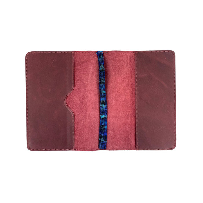 Interior view of the brown leather Full Grain Leather Journal Cover for Moleskine Cahier XL (7.5 x 9.75 in.) by Hide & Drink, featuring open pages and a pen. This notebook case celebrates the artistry of small batch production from Guatemala.