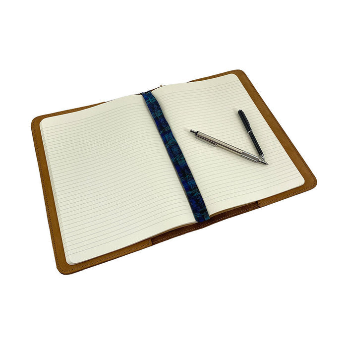 Front view of the vintage leather Full Grain Leather Journal Cover for Moleskine Cahier XL (7.5 x 9.75 in.) by Hide & Drink, presenting an elegant design. Perfect for creatives who appreciate handmade craftsmanship.
