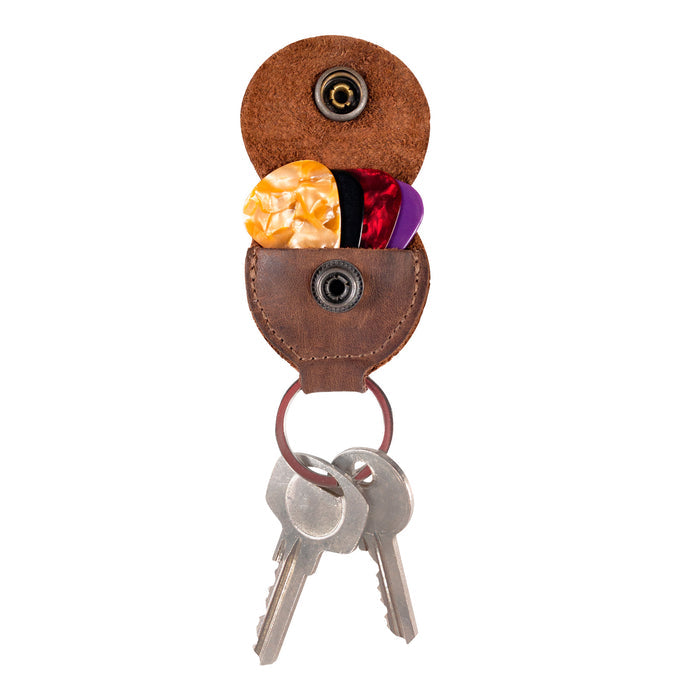 Showcasing the Key Chain & Guitar Pick Holder by Hide & Drink, this image features a compact Guitar Pick Holder with Ring and key organizer design. Perfect for guitar players, it emphasizes its Full Grain Leather craftsmanship, highlighting the small batch production and artisan quality with hand cut and hand sewn details, all made in La Antigua Guatemala & Oaxaca Mexico.