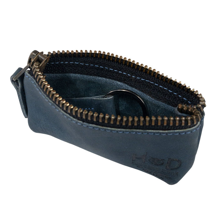 Hide & Drink Key Holder Zippered Pouch showcasing its practical use for everyday items, including coins and charging cables. Crafted in full grain leather, highlighting artisan dedication.