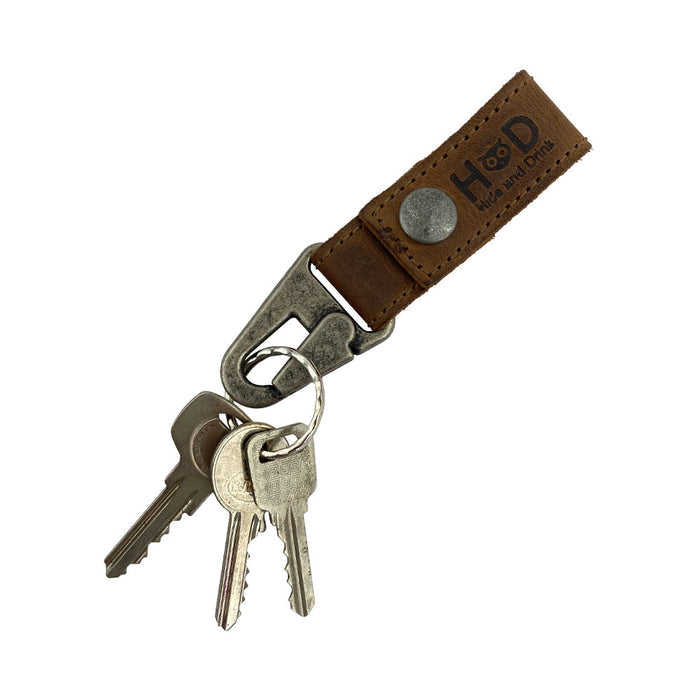 Key Ring Holder by Hide & Drink shown with keys attached, made from Full Grain Leather for durability. This artisan product represents small batch production, hand cut and hand sewn techniques, and is fire branded, all handmade in La Antigua Guatemala & Oaxaca Mexico.