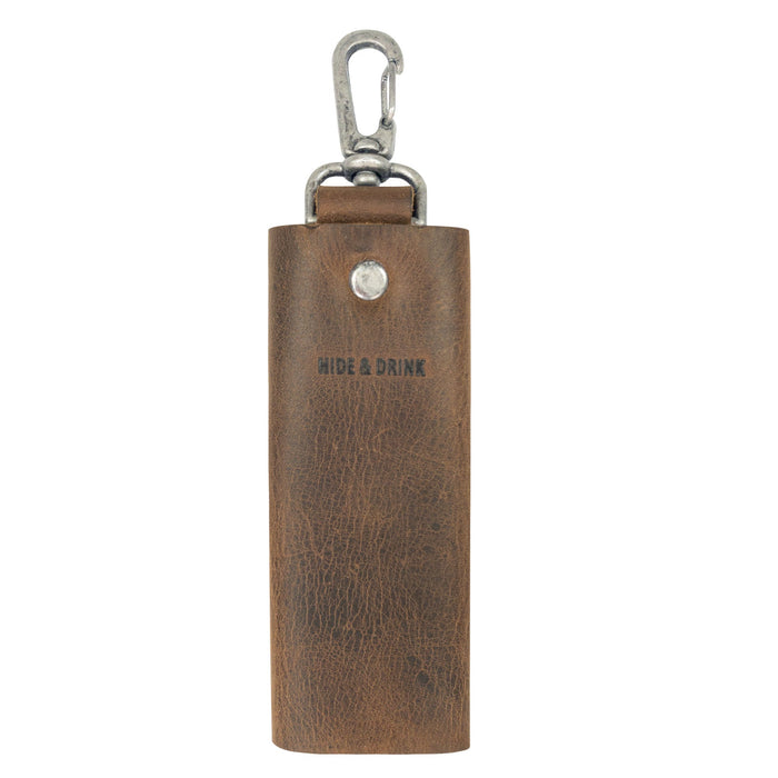 Showcasing a distinctive Key Wrap by Hide & Drink, this piece features a luxurious texture and lobster clasp. This Key Wrap functions as a smart keychain holder and pocket accessory, crafted from full grain leather through meticulous small batch production. It exemplifies hand cut and hand sewn skills of artisans from La Antigua Guatemala & Oaxaca Mexico.
