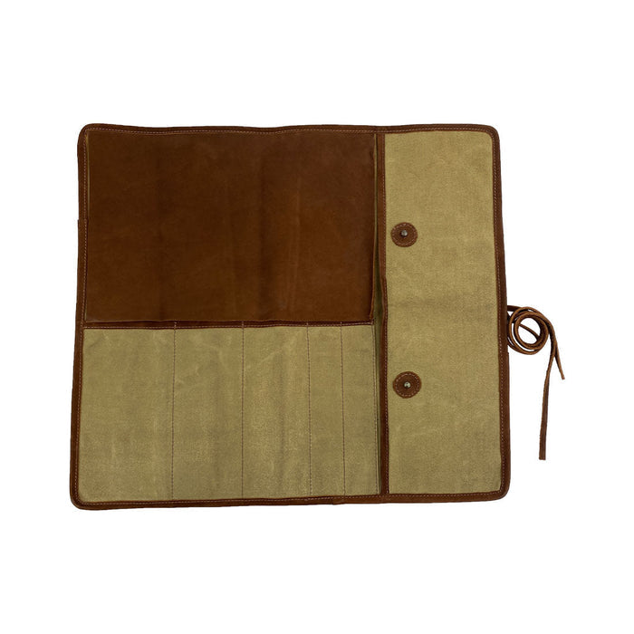 Hide & Drink Knife Roll (5 Pockets) elegantly folded, crafted from exquisite Full Grain Leather. This Chef Knife Bag functions as a portable carrying case for knives, showcasing the meticulous artisan workmanship from small batch production, with hand cut and hand sewn features.