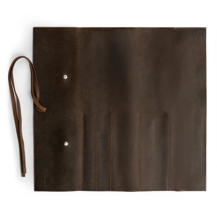 Hide & Drink Knife Roll (5 Pockets) opened to reveal its inner pockets made from durable Full Grain Leather. This Chef Knife Bag is a stylish portable carrying case for knives, benefiting from handmade techniques and small batch production done by skilled artisans in La Antigua Guatemala & Oaxaca Mexico.