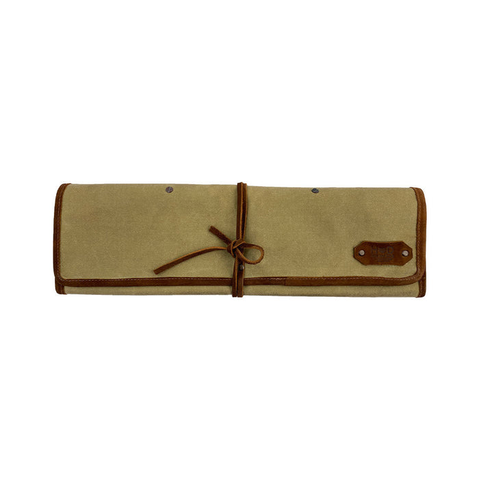 Hide & Drink Knife Roll (5 Pockets) displayed with a set of culinary tools, crafted from Full Grain Leather. This Chef Knife Bag serves as a portable carrying case for knives, epitomizing quality artisan craftsmanship with handmade details, small batch production, and hand cut and hand sewn practices.