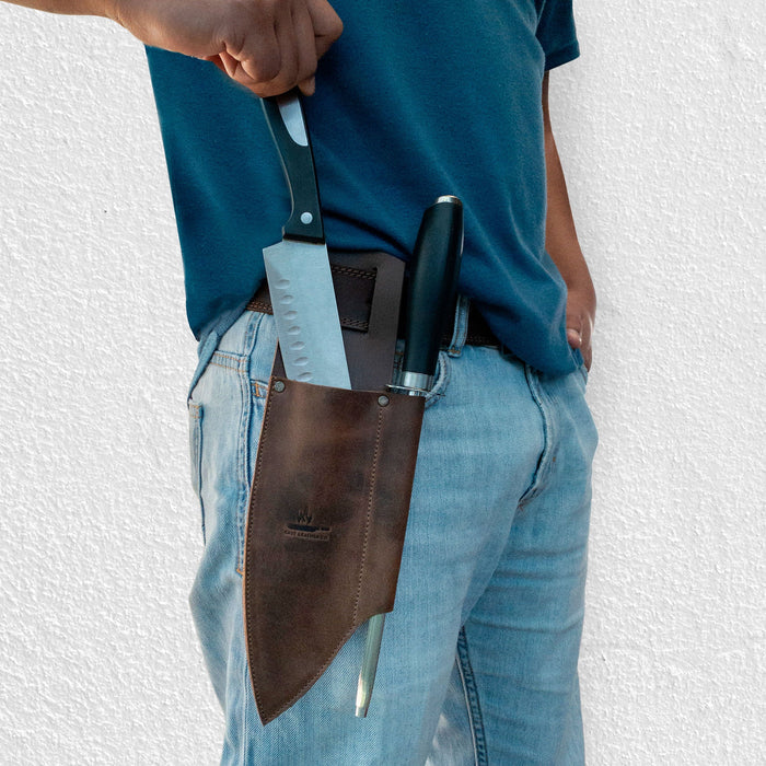 Knife Sheath with Sharpener Slot by Cast Leather Co., worn on a belt showcasing a rustic sleeve for a chef knife and sharpener. This knife holster for belt is made from high-quality full grain leather, emphasizing small batch production and artisan skills, handcrafted in La Antigua Guatemala.