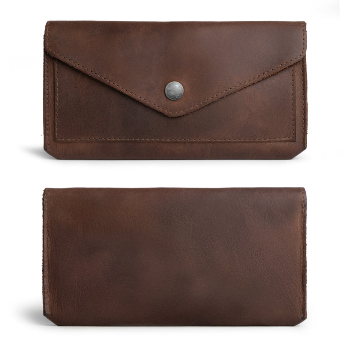 The exterior view of the Large Female Wallet by Hide & Drink, highlighting its vintage design and sturdy snap closure. As a Travel Organizer for Women, this Vintage Money and Card Holder is crafted from Full Grain Leather, embodying the essence of artisan quality through Small Batch Production techniques, and is handmade in La Antigua Guatemala & Oaxaca Mexico.