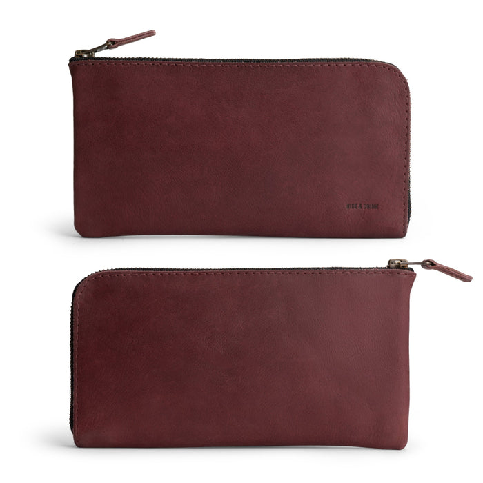 Front view of the Large Zippered Wallet by Hide & Drink in Sangria, perfect for showcasing its quality. This Long Zippered Wallet for Men and Women is not just a Card Holder, but also a Card Organizer and Bill Holder, making it an essential Travel Accessory. Made from Full Grain Leather in La Antigua Guatemala & Oaxaca Mexico, reflecting artisan craftsmanship.