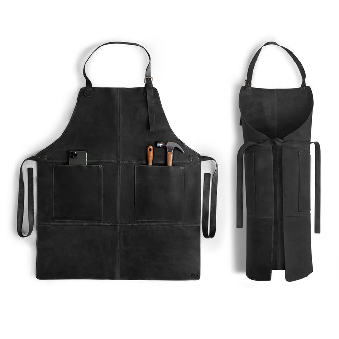 Hide & Drink Leather Apron in black with spacious pockets and adjustable straps, showcasing the durability of full grain leather. This handmade Leather Apron provides utility and style, perfect for various uses.