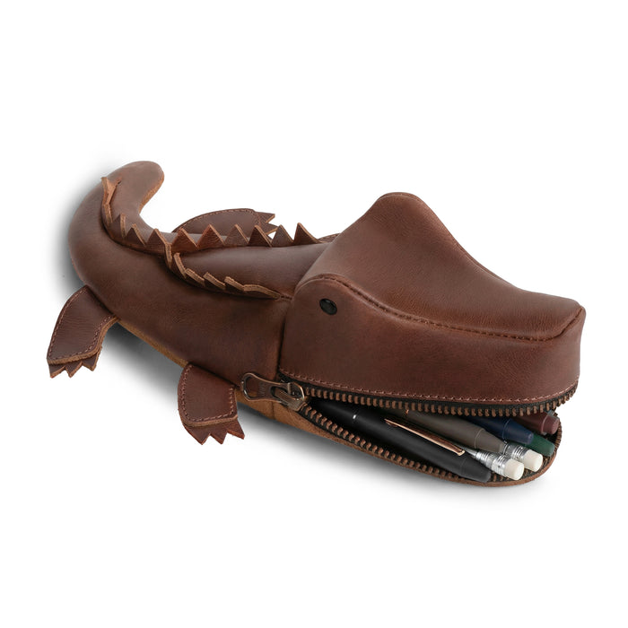 Stylish Leather Gator Pouch by Tudi Frudi, featuring a crocodile shape perfect for holding supplies. This versatile Gator Leather Pouch serves as a crocodile-shaped pencil pouch, alligator-shaped coin purse, or small charger cable holder. Made from full grain leather through small batch production, it's hand cut and hand sewn, showcasing artisan craftsmanship. Ideal as a change bag or scissors case, this unique, handmade item from La Antigua Guatemala & Oaxaca, Mexico, elevates your organization game.