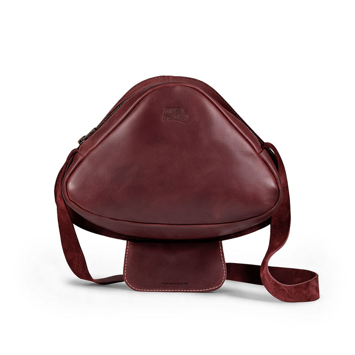 Mushroom-Shaped Leather Shoulder Bag by Tudi Frudi, featuring a whimsical design with an adjustable strap. This versatile crossbody bag is perfect for travel or as a messenger bag, crafted from Full Grain Leather, showcasing stockyardX's small batch production. Hand cut and sewn for quality, this artisan bag is handmade in La Antigua Guatemala.