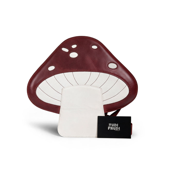 The Mushroom-Shaped Leather Shoulder Bag by Tudi Frudi, complete with tags and branding, showcasing its unique handmade qualities. This bag is perfect for use as a crossbody or messenger bag, made from Full Grain Leather with small batch production, reflecting artisan craftsmanship from La Antigua Guatemala.