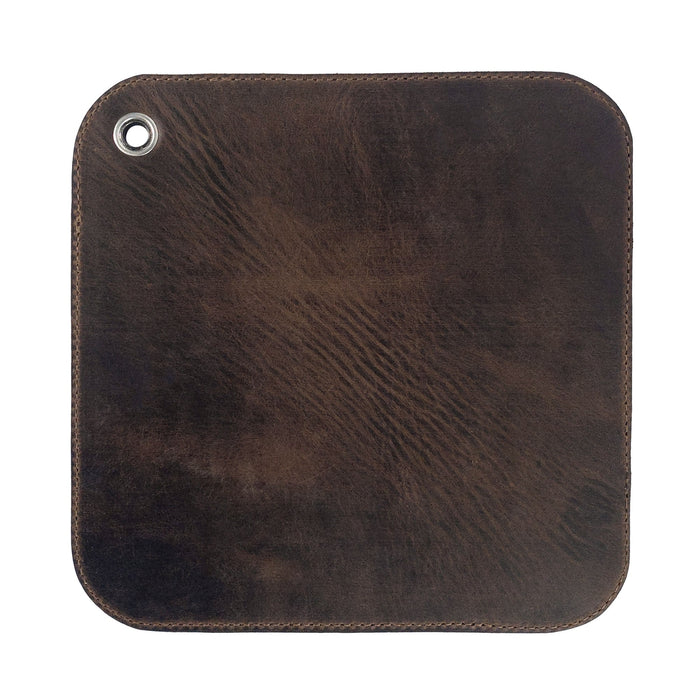 An elegant view of the underside of the Cast Leather Co. Leather Oven Mitt & Trivet, highlighting its smooth full grain leather finish. This versatile hot pot pad (potholder) represents the essence of artisan craftsmanship and small batch production, handmade in La Antigua Guatemala.