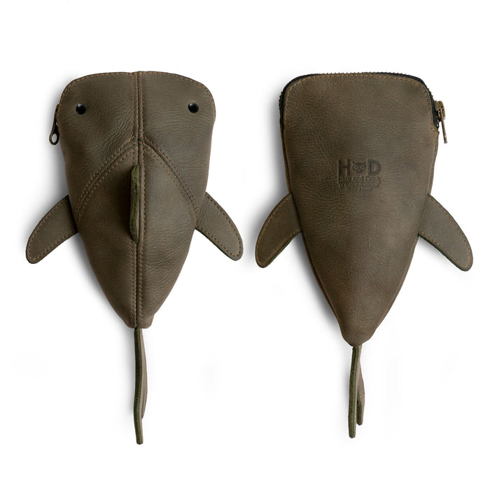 The green Leather Shark Pouch by Hide & Drink, showing its playful design and zippered closure. This unique case is perfect for organize pens and art supplies, serving as a shark shaped pencil purse or cable holder. Each pouch is handcrafted from full grain leather in La Antigua Guatemala & Oaxaca Mexico.