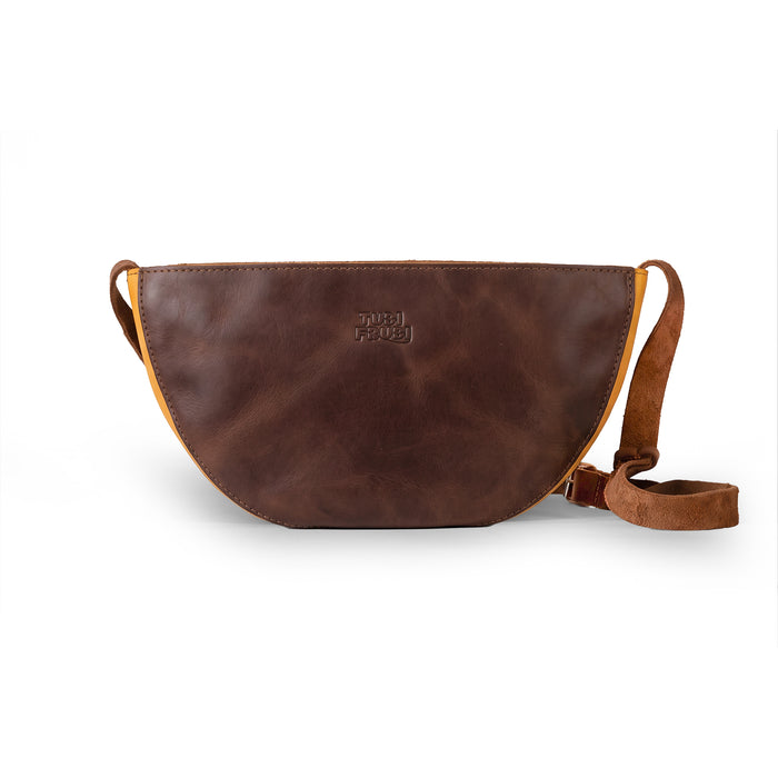 Top view of the Lemon-Shaped Shoulder Bag by Tudi Frudi, showing the zipper compartment for secure storage. This Lemon-Shaped Shoulder Bag with Adjustable Strap is ideal as a Messenger Bag and Vintage Purse. It features Full Grain Leather and is made through Small Batch Production, hand cut and sewn by talented artisans in La Antigua Guatemala & Oaxaca Mexico.