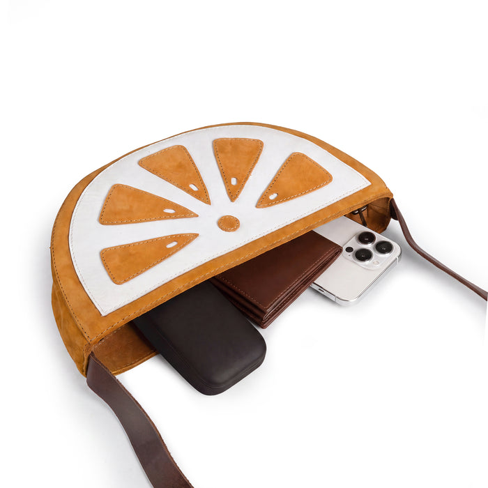 Inside view of the Lemon-Shaped Shoulder Bag by Tudi Frudi, displaying its spacious interior. This Lemon-Shaped Shoulder Bag with Adjustable Strap is functional as a Messenger Bag and Vintage Purse. Made from Full Grain Leather with exquisite craftsmanship through Small Batch Production, hand cut and hand sewn by artisans in La Antigua Guatemala & Oaxaca Mexico.