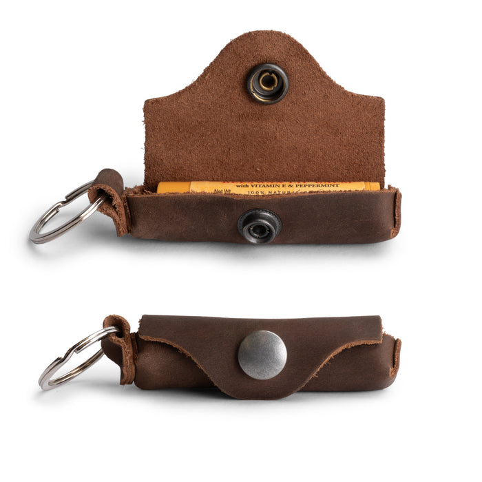 Rustic Lip Balm Key Chain by Hide & Drink featuring a keychain holder design with full grain leather, perfect for lip protection. Classic vintage style with brass metal clasp. Handcrafted in La Antigua Guatemala.