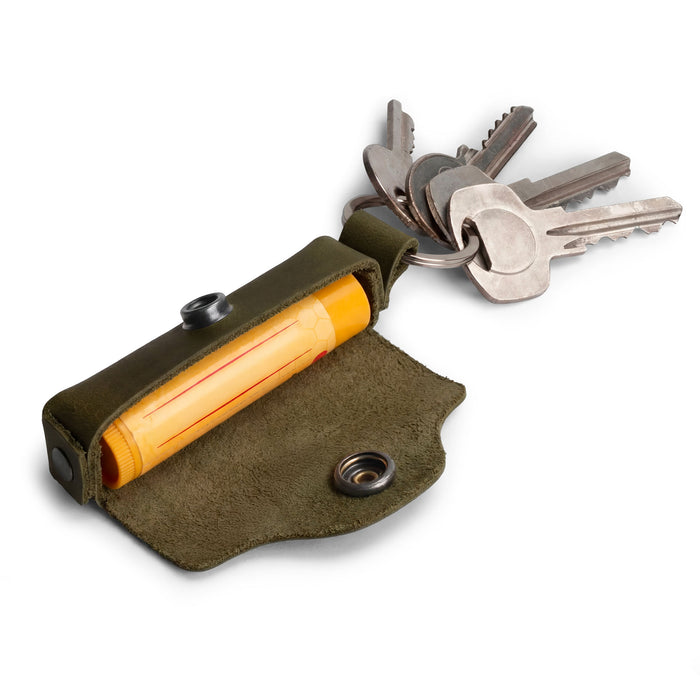 Slim profile of the Lip Balm Key Chain by Hide & Drink showcasing its durable design with a brass metal clasp. This lip balm keychain holder is made from full grain leather, providing stylish lip protection. Ideal for daily use, this classic vintage accessory is hand cut and hand sewn, showcasing the craftsmanship of small batch production from La Antigua Guatemala & Oaxaca Mexico.