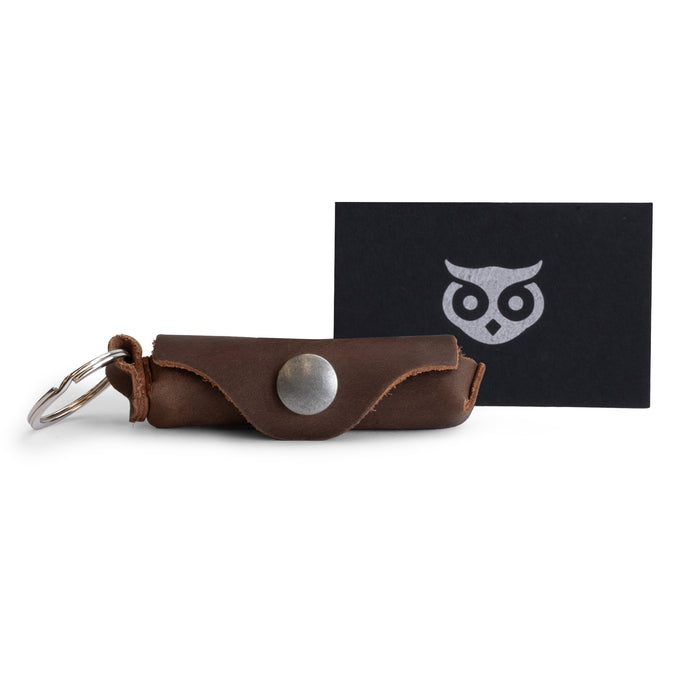 Versatile Lip Balm Key Chain by Hide & Drink featuring a keychain holder for convenient lip balm storage. Made from full grain leather with a classic vintage touch and sturdy brass metal clasp. Handmade in La Antigua Guatemala.