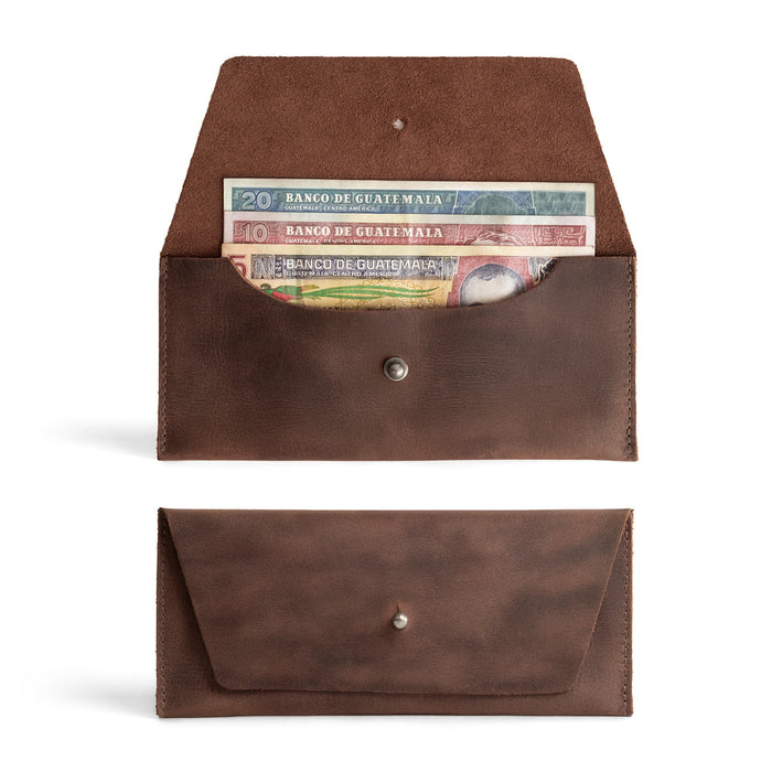 Image of the Long Utility Pouch by Hide & Drink, showcasing the handmade full grain leather wallet with cash stored inside. This stylish wallet is perfect for carrying and storing cash, coins, and cards, crafted with care in La Antigua Guatemala & Oaxaca Mexico.