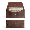 Image of the Long Utility Pouch by Hide & Drink, showcasing the handmade full grain leather wallet with cash stored inside. This stylish wallet is perfect for carrying and storing cash, coins, and cards, crafted with care in La Antigua Guatemala & Oaxaca Mexico.