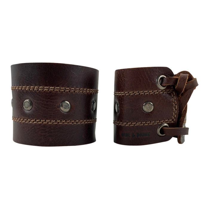 Detailed image of the Men's Wristband by Hide & Drink, showcasing the unique weaving and fastening method that ensures a secure fit. This bracelet is crafted from full grain leather, symbolizing artisan quality and style. Men's Wristband Handmade, Full Grain Leather, StockyardX, Small Batch Production, Hand Cut, Hand Sewn, Fire Branded, Artisan, Handmade in La Antigua Guatemala & Oaxaca Mexico.