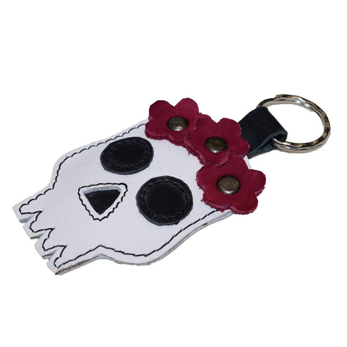 Close-up of the Mexican Skull Keychain by Hide & Drink, showcasing its charming floral details and vibrant colors. Made with Full Grain Leather, this key ring is a fantastic accessory for celebrating Dia de los Muertos. Each piece is handmade, fire branded, and embodies artisan quality from La Antigua Guatemala & Oaxaca Mexico.