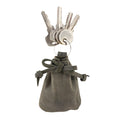 A Mini Medieval Pouch Keychain by Hide & Drink showcasing its stylish design in deep green leather. This tiny bag with keyring effectively acts as a coin pouch and highlights premium craftsmanship from La Antigua Guatemala.