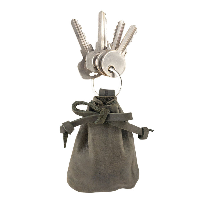 A Mini Medieval Pouch Keychain by Hide & Drink showcasing its stylish design in deep green leather. This tiny bag with keyring effectively acts as a coin pouch and highlights premium craftsmanship from La Antigua Guatemala.